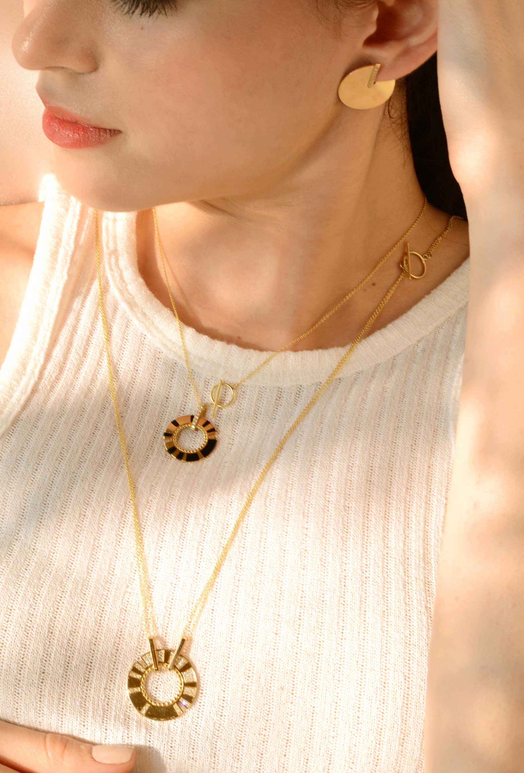 18K yellow gold earrings and ring from the second skin collection on a woman - Cynthia Raffoul