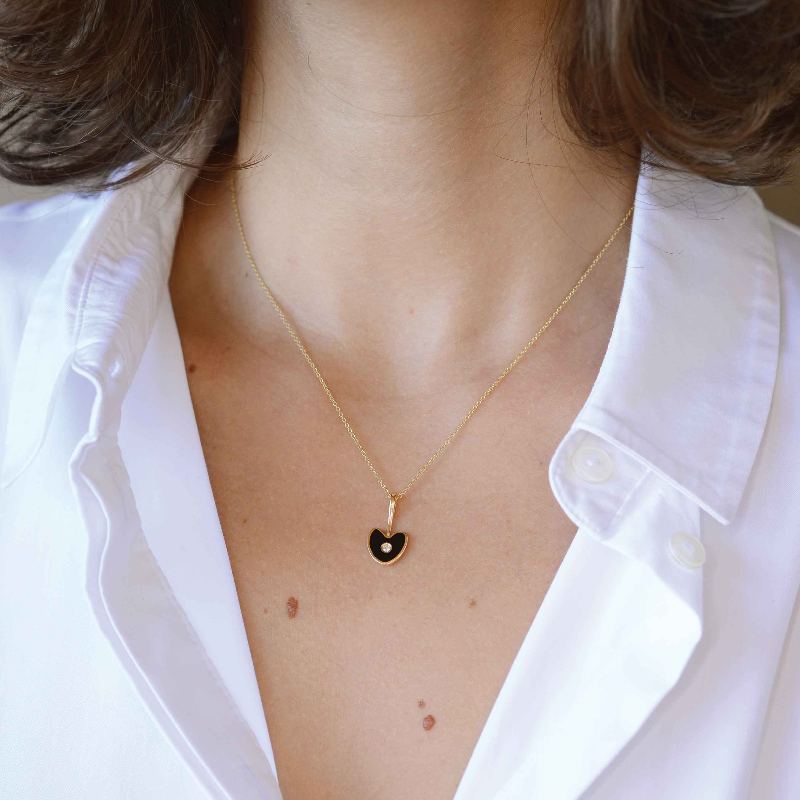 black gold heart with white diamond on a woman
