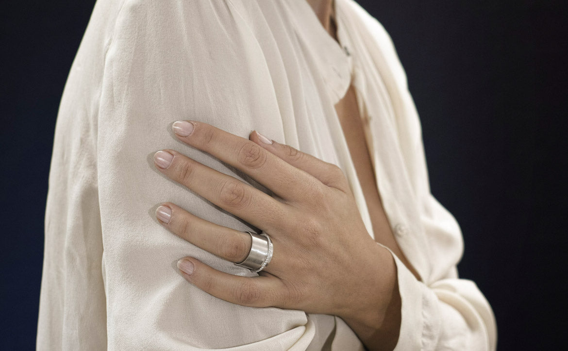 gold ring with white diamonds on woman hand