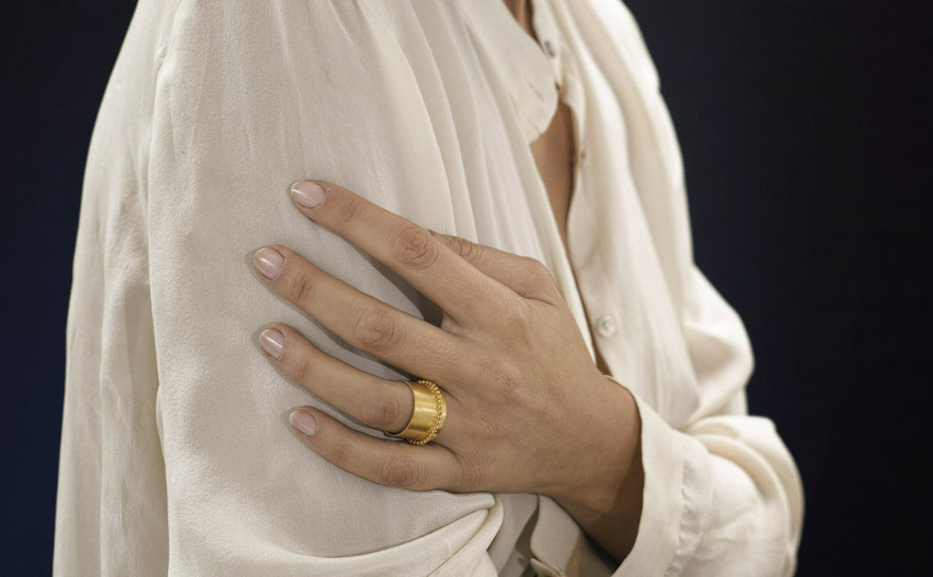 yellow gold ring on a woman