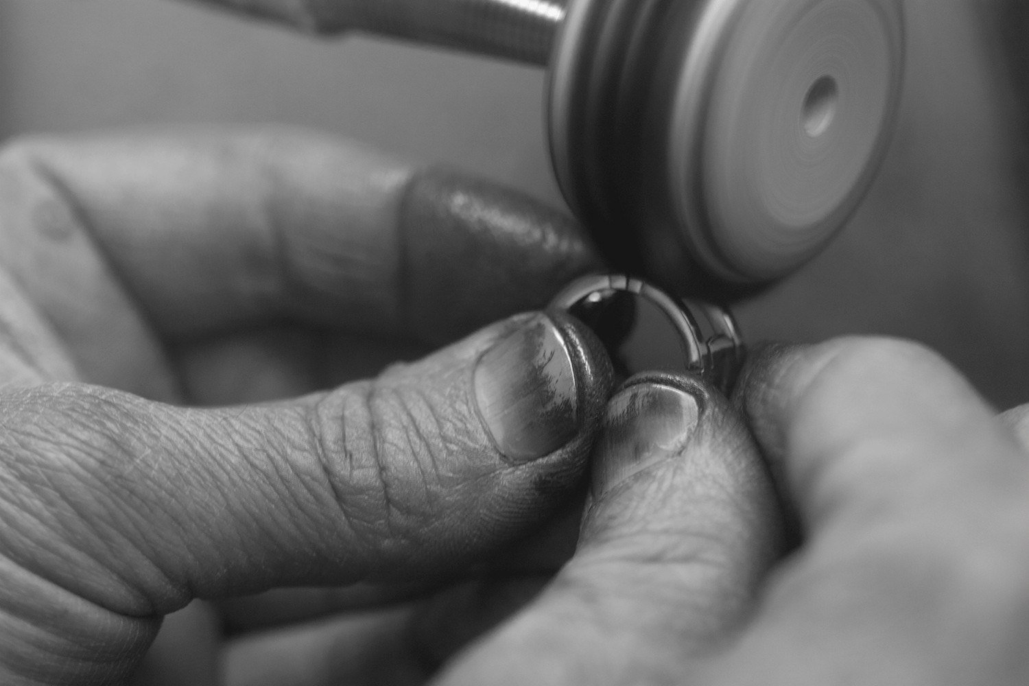 An artisan polishing a second skin gold ring - Cynthia Raffoul