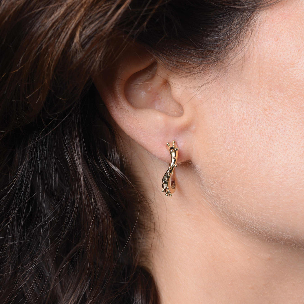 gold earrings on a woman
