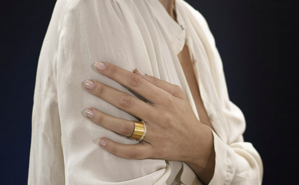 gold ring with white diamonds on a woman hand